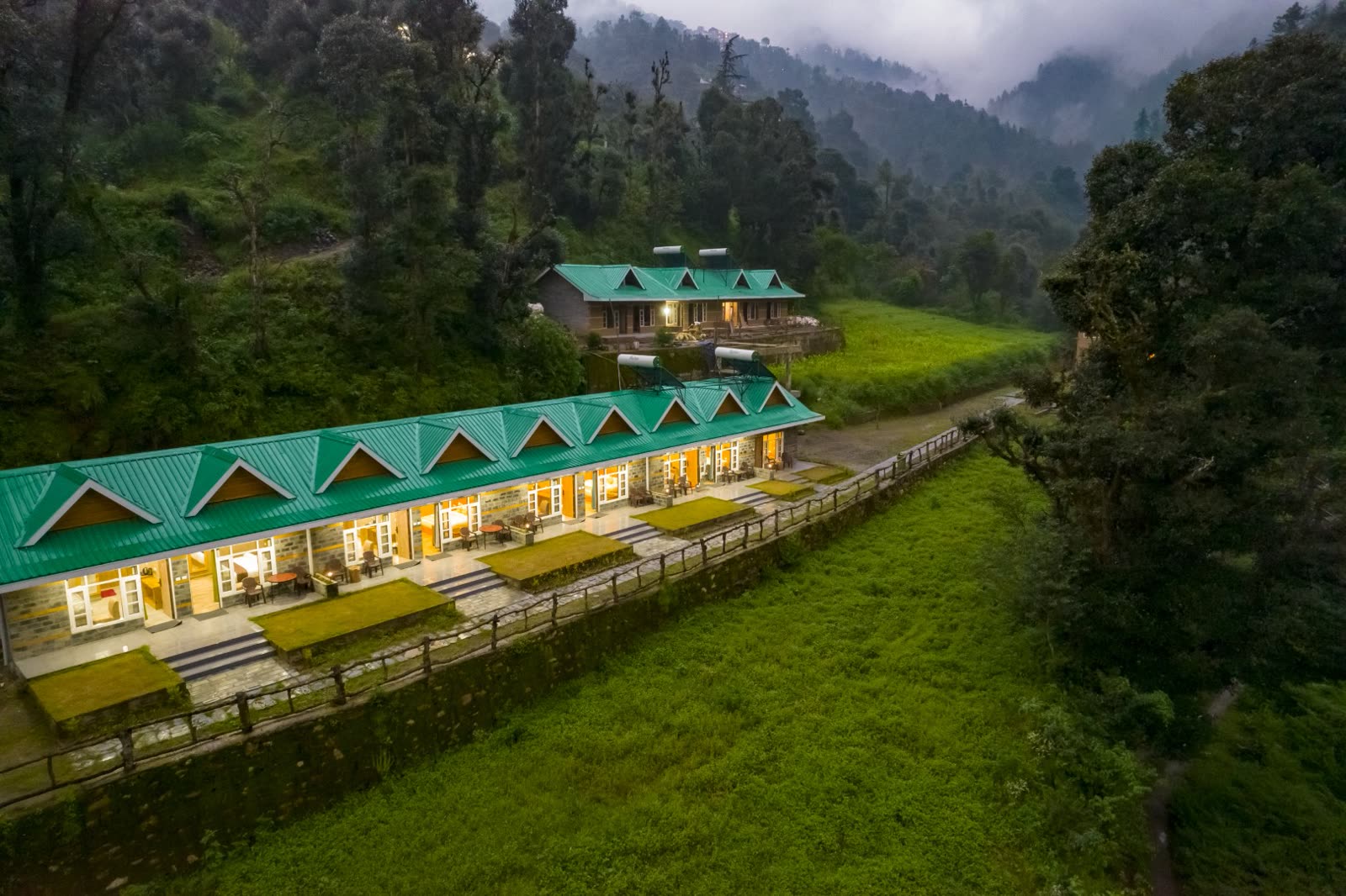 Backwoods Retreat cottages surrounded by a green Himalayan valley near Shimla